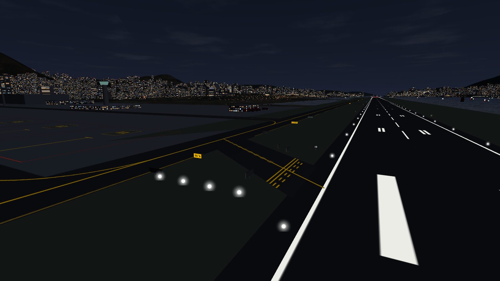 The same view at night: the yellow centre lines and dashes show up against the dark ground, and the B1 sign is lit.