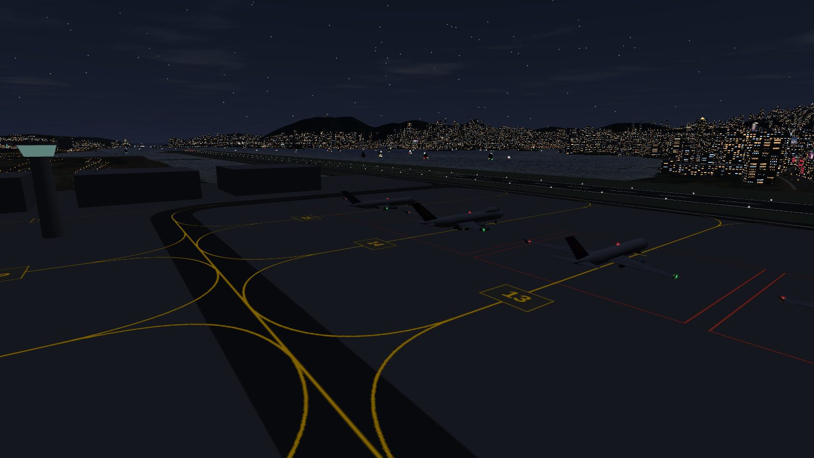 The same stands at night, with the yellow lines and numbers still visible on the dark apron.