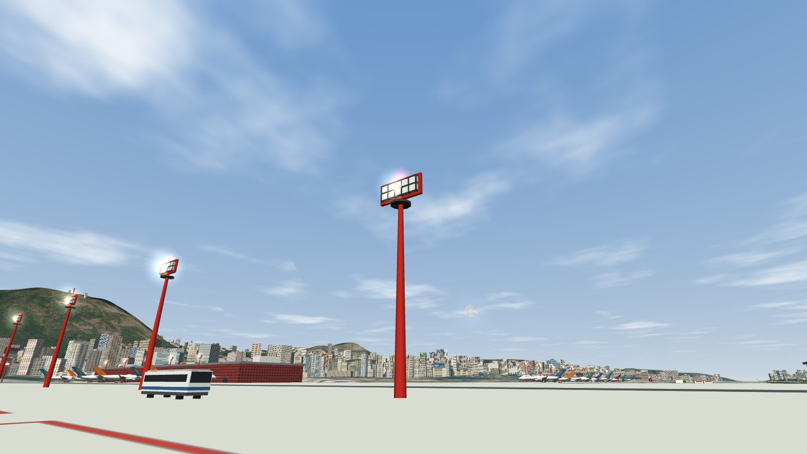 A tall red floodlight mast on the Kai Tak apron, a frame of lamps on top, with more masts and an apron bus beyond.