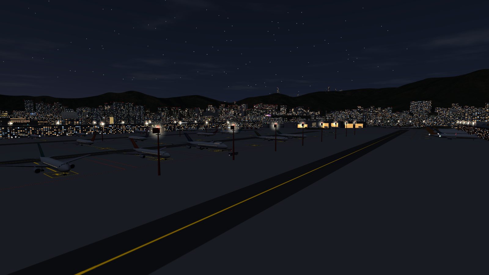 The apron at night: red masts with glowing lamp heads and red obstruction lights over the parked aircraft.