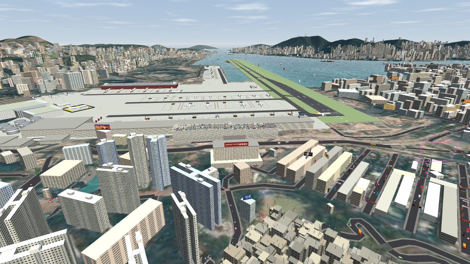 An aerial view of the car park along the runway end of the terminal, with the airport hotel across the road.