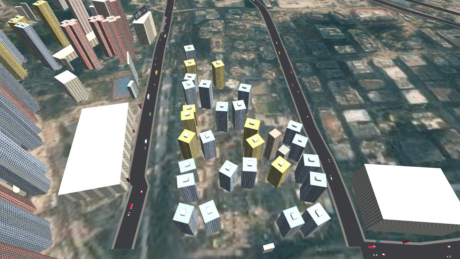 Looking down on an estate of tall blocks in yellow, white and grey, arranged in loose rows between two roads.