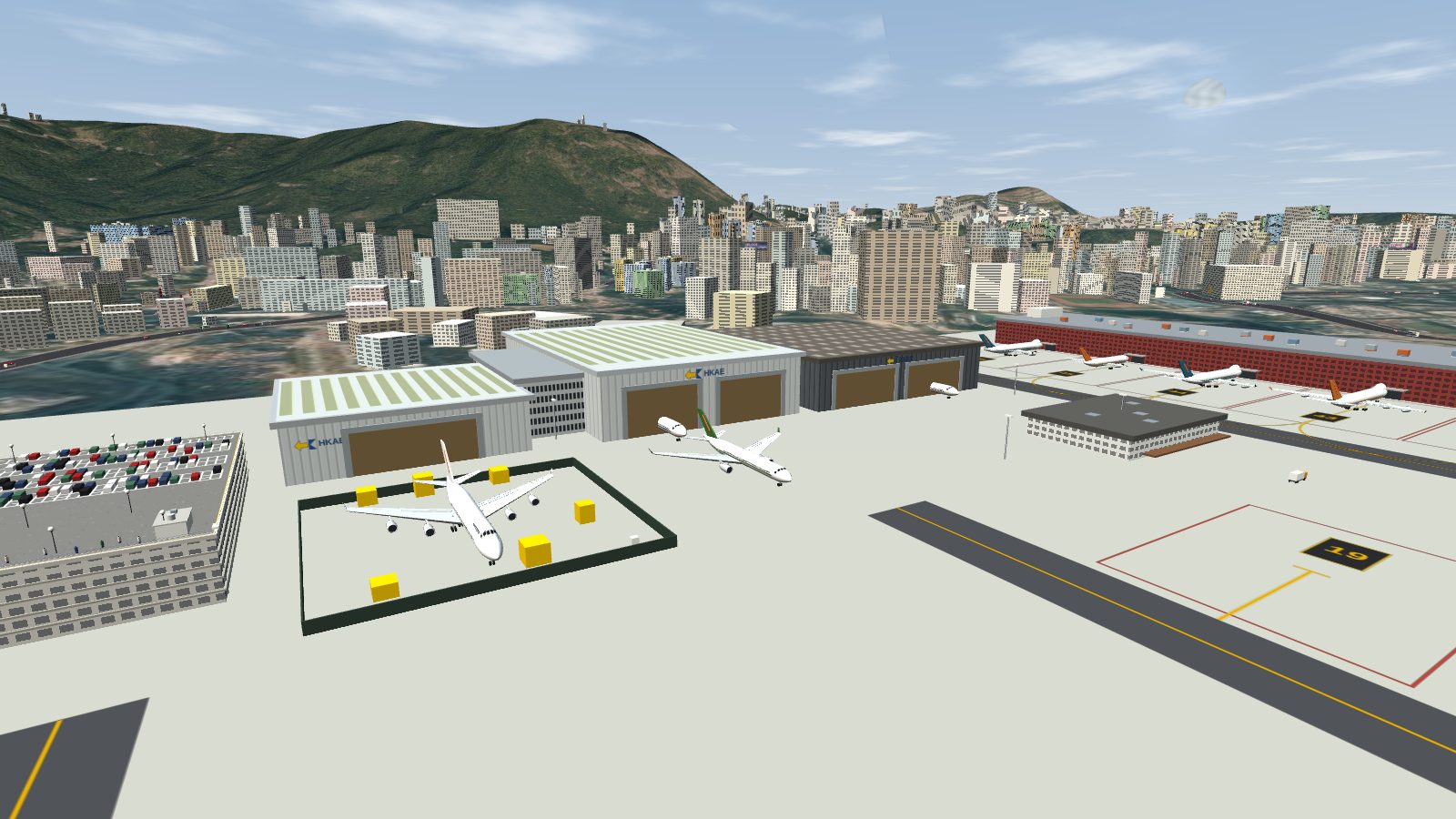 Three hangars with open door bays beside a fenced compound.