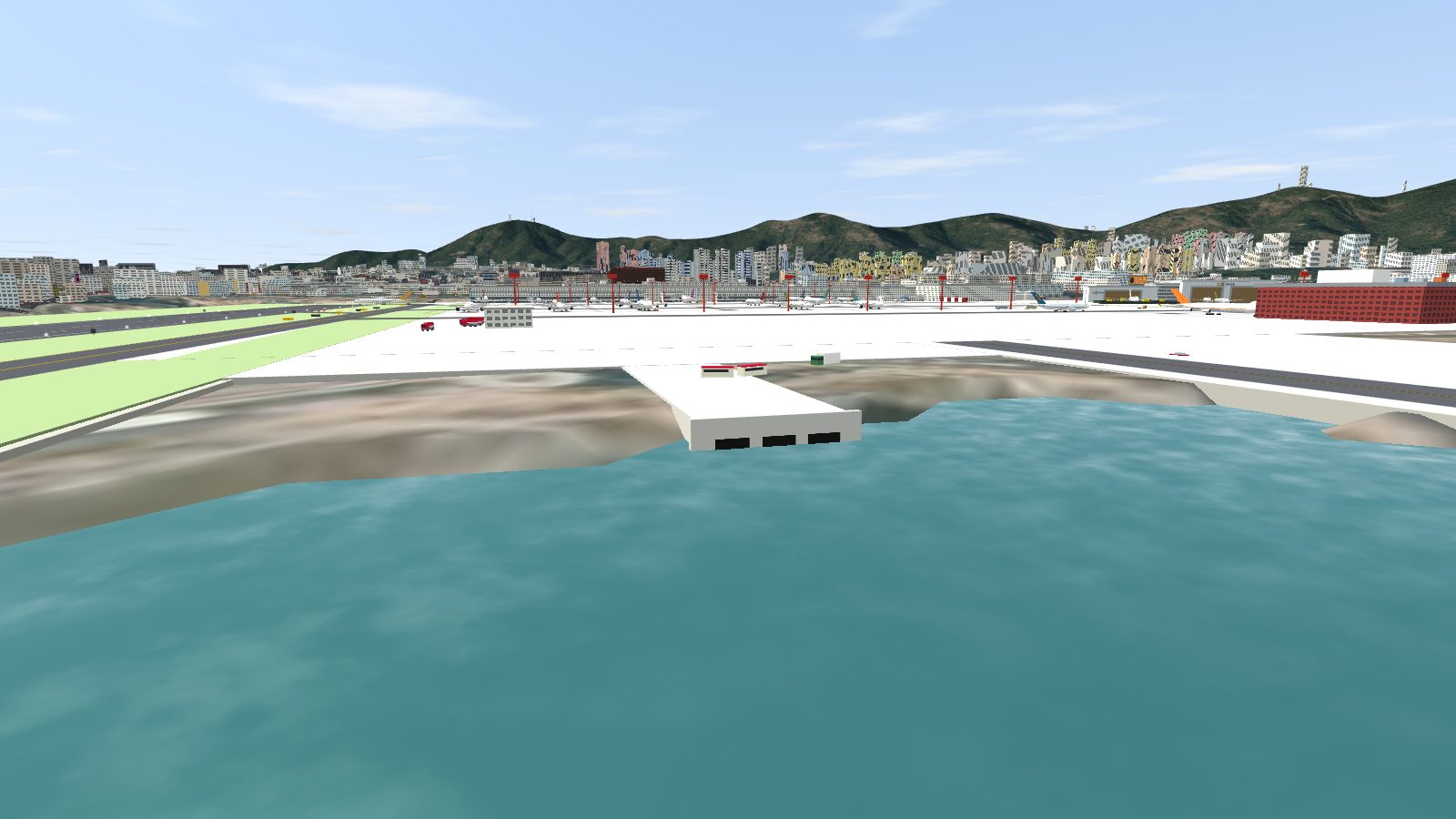 A concrete culvert headwall with three dark openings at the water's edge at the head of the inlet, the apron beyond.