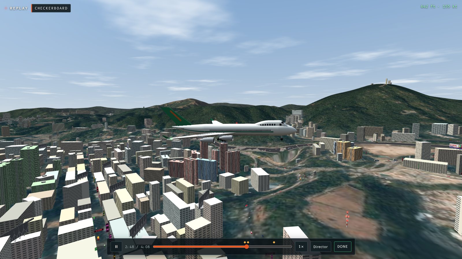 A 747 low over Kowloon rooftops seen from a camera beside the approach path, with the replay bar along the bottom.