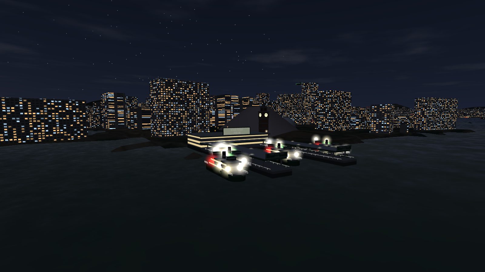 The Tsim Sha Tsui pier at night: lit saloon windows on the ferries, the lit hall and the clock faces glowing.