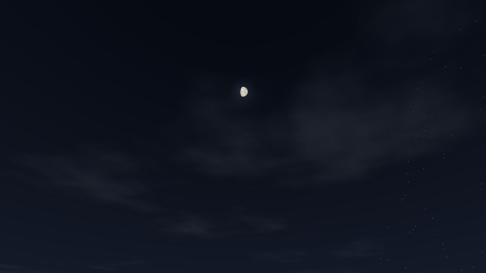 A waxing gibbous moon in a dark sky with stars.